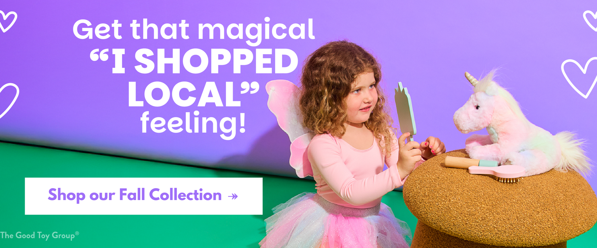 Young girl in a pink fairy costume with a unicorn toy against a purple and green background, promoting a 'shop local' message.